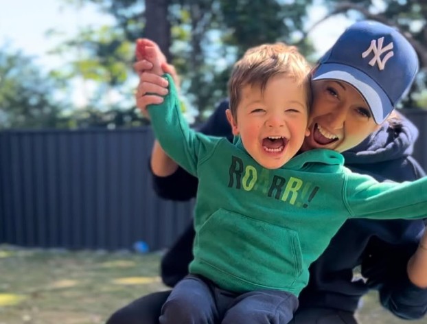 Emma laughing with her nephew in the backyard